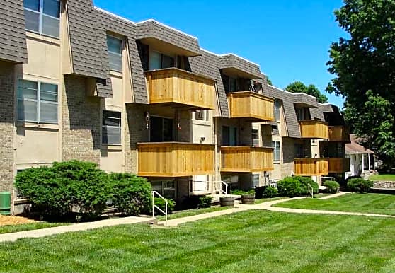 a row of apartment buildings with wooden balconies